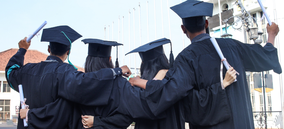 Group of graduates holding diplomas