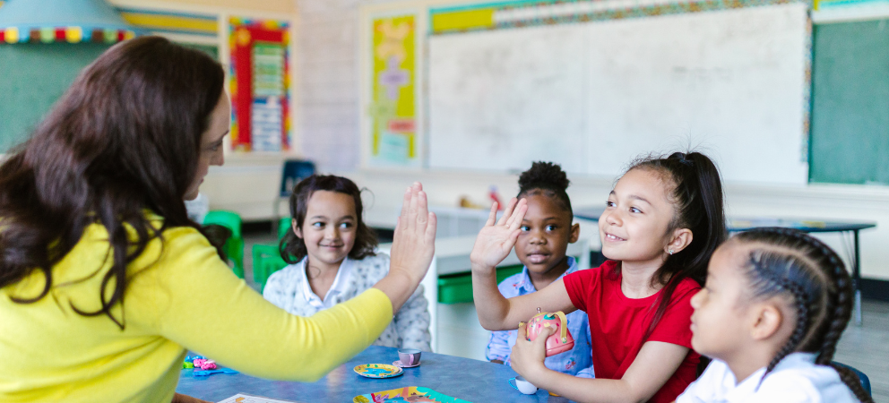 Teacher with group of small group of young students