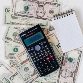 Calculator with money and blank notepad